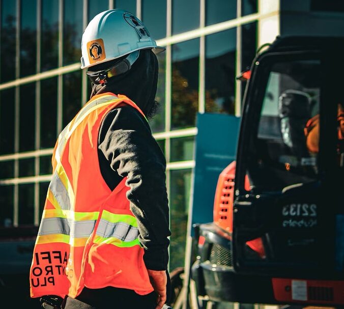 Construction worker in safety gear at an urban site in Ontario, Canada.